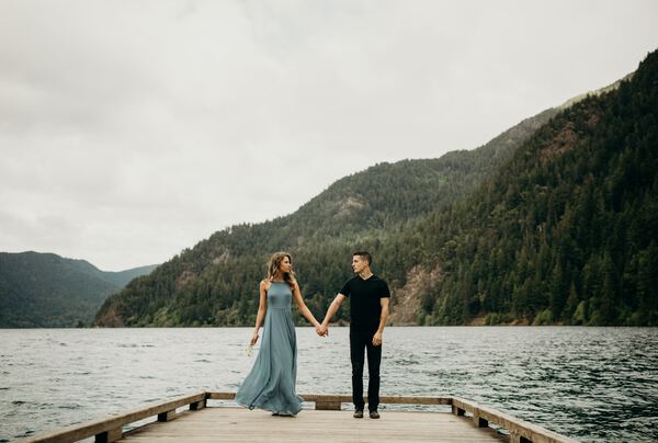 Couple holding hands on a dock