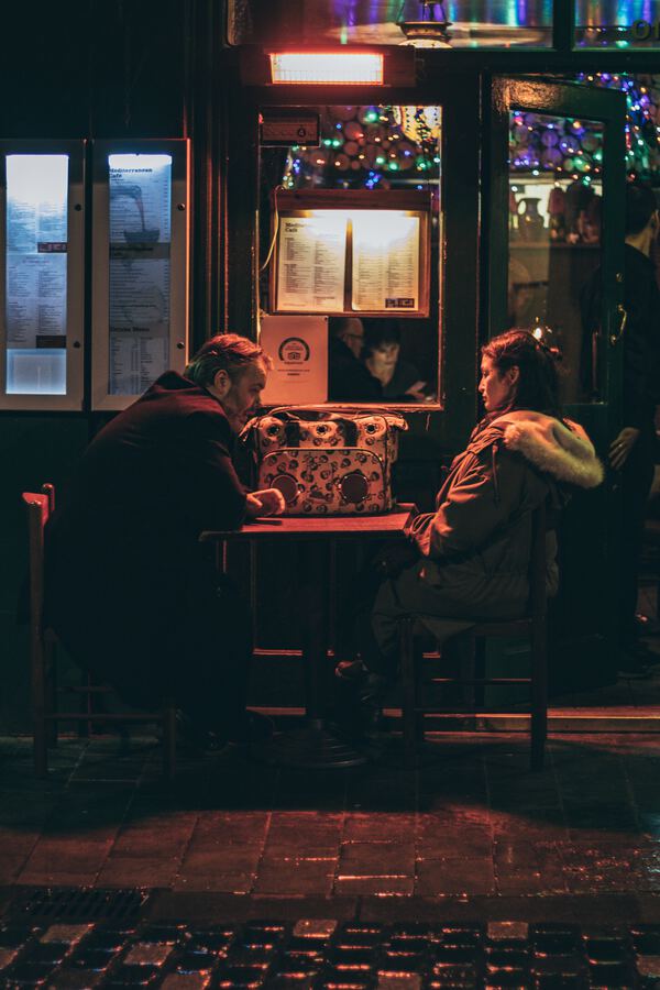 Couple talking at a table in a dimly lit restaurant