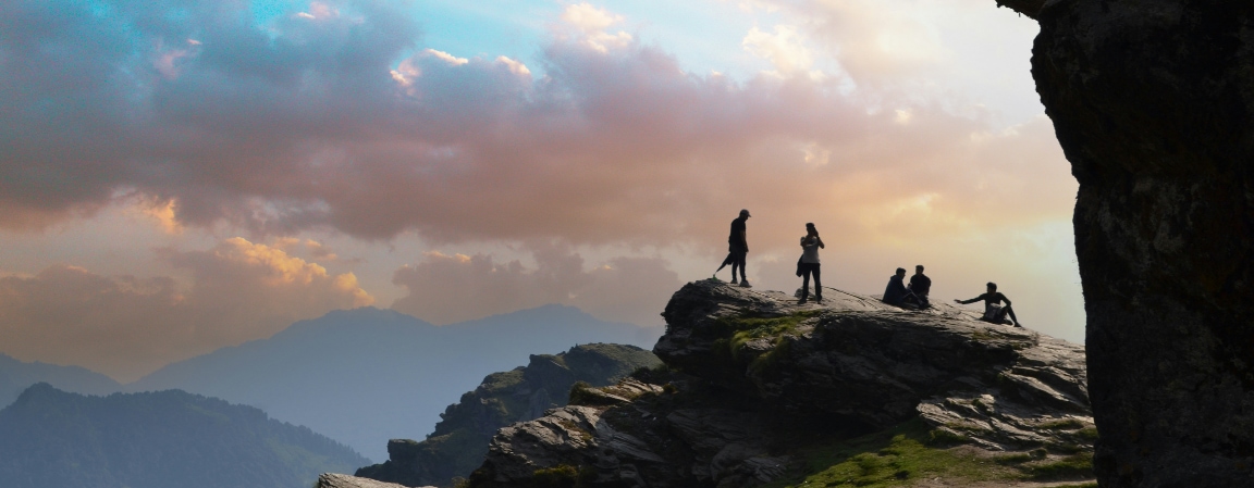 A group of people standing on top of a mountain