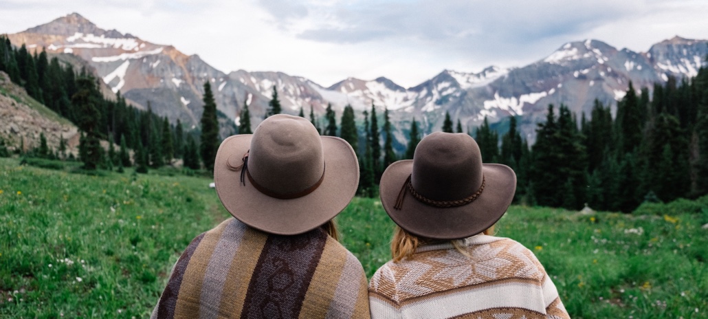 Couple sitting overlooking mountain range