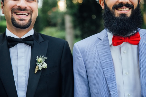 Two men in wedding attire, standing at the altar