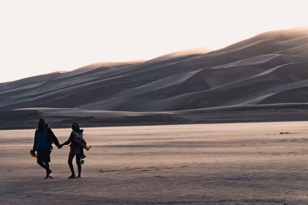 Couple holding hands on a walk in a desert