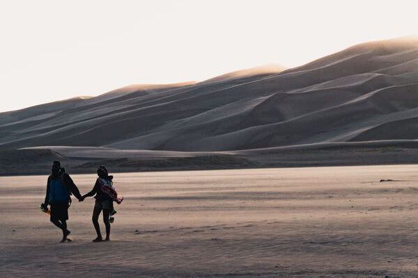 Couple holding hands on a walk in a desert