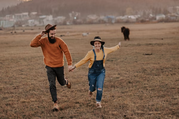 Happy couple running in a field