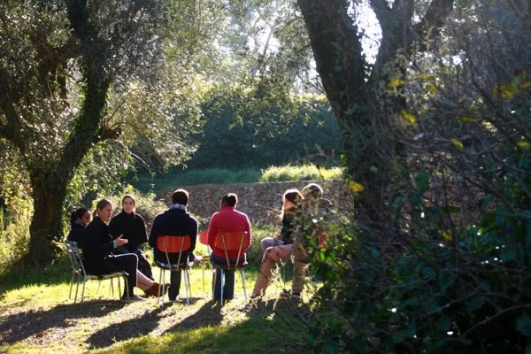 People sitting under a tree in the springtime