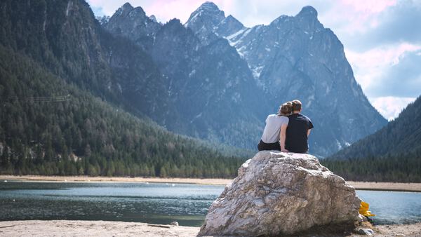 Couple sitting together on a boulder